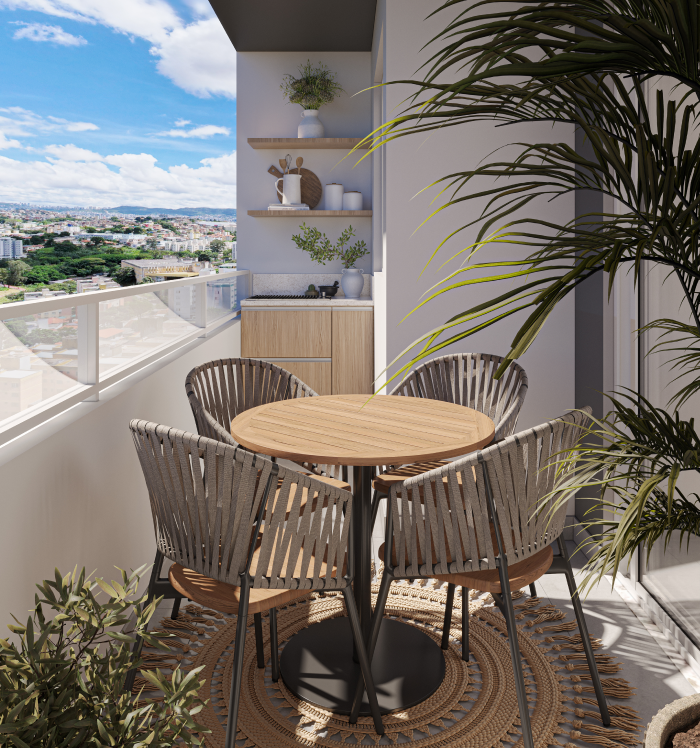 A imagem mostra uma varanda gourmet em um apartamento com vista para a cidade. O ambiente é moderno e acolhedor, com móveis de design leve e elementos naturais, como plantas e tapete. Varanda do apartamento do Benvindo Condomínio Clube.